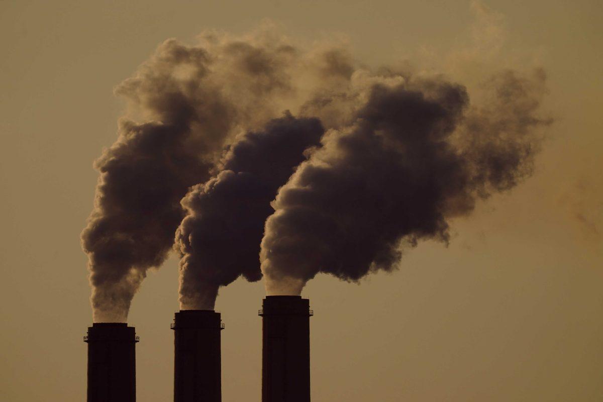 FILE - In this Sept. 18, 2021 photo, emissions rise from the smokestacks at the Jeffrey Energy Center coal power plant as the suns sets, near Emmett, Kans. As climate change bakes the planet, dozens of nations including the U.S. and many local governments are putting a price tag on greenhouse gas emissions that are causing more floods, droughts and other destructive events. (AP Photo/Charlie Riedel, File)