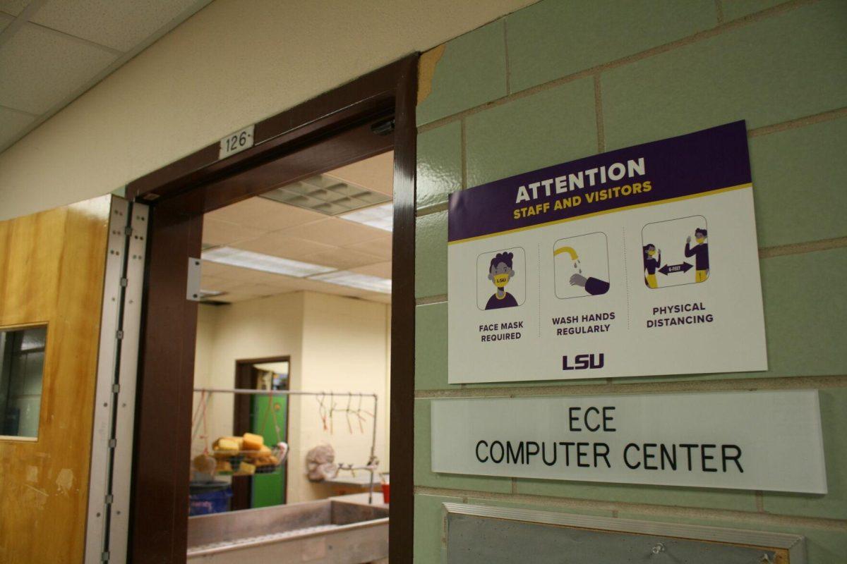 A COVID-19 sign is posted outside room 126 of the Electrical Engineering Building on Wednesday, May 18, 2022.