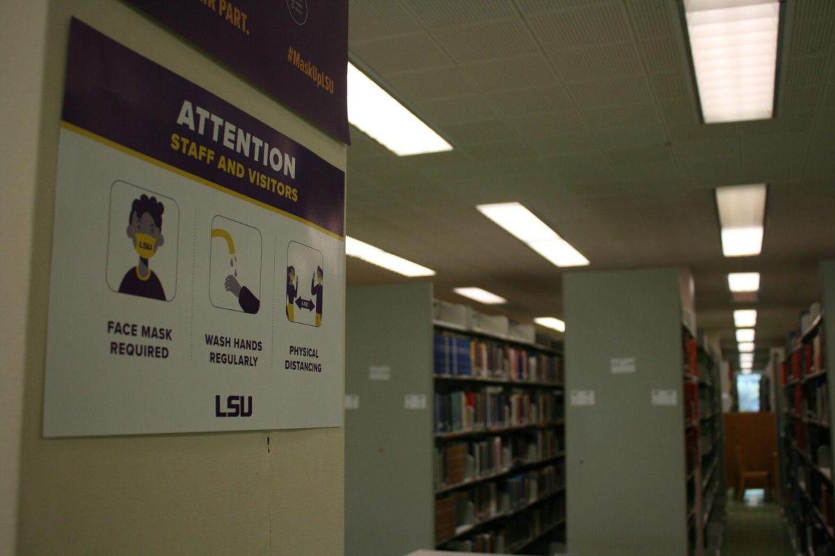 A COVID-19 sign hangs on the second floor of the LSU Library on Monday, May 16, 2022.