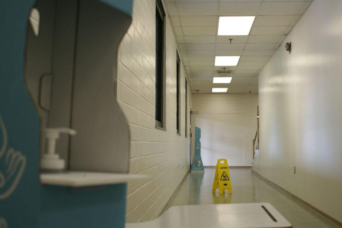 Two blue "Hand Sanitizing Stations" sit in a corridor of Coats Hall's first floor on Monday, May 16, 2022.&#160;