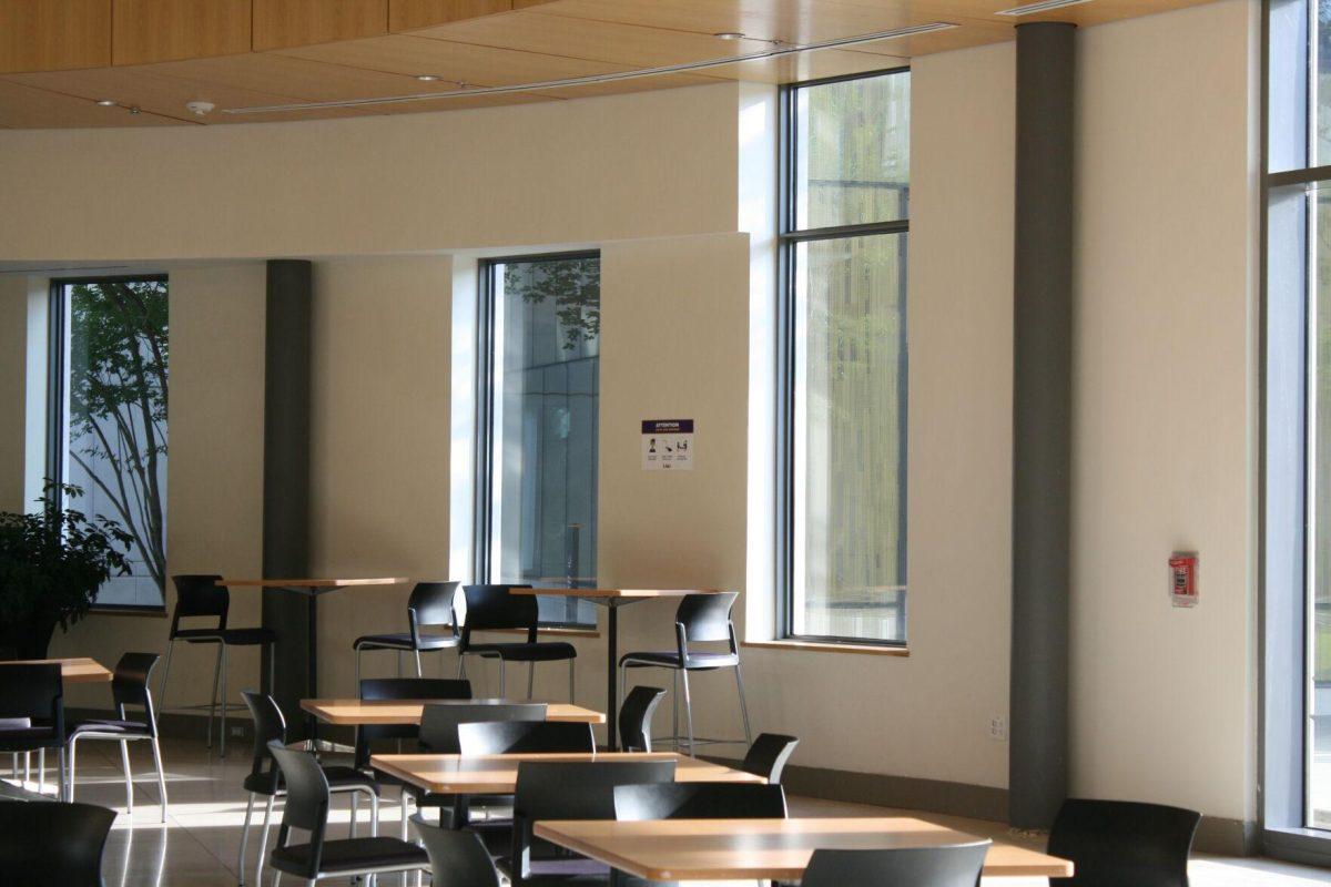 As light shines into the common area of the Business Education Complex on Wednesday, May 18, 2022, a COVID-19 flyer presides over the room.