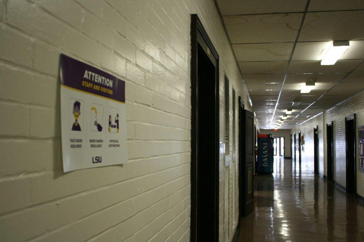 A COVID-19 warning sign remains posted on the first floor of Prescott Hall on Wednesday, May 18, 2022.