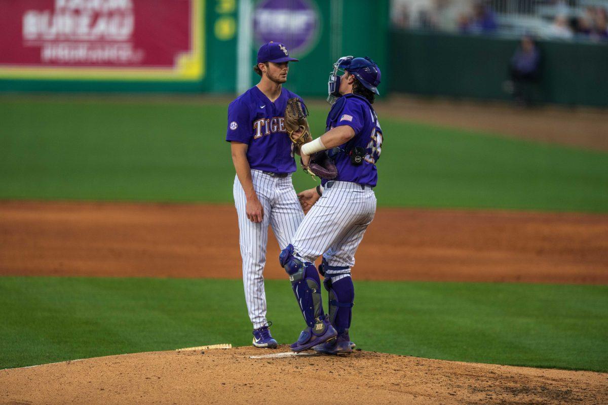 LSU baseball sophomore right-handed pitcher Ty Floyd (9) exchanges a few words with graduate catcher Tyler McManus (26) Tuesday, April 19, 2022, during the game against University of Louisiana Lafayette at Alex Box Stadium on Gourrier Avenue in Baton Rouge, La.