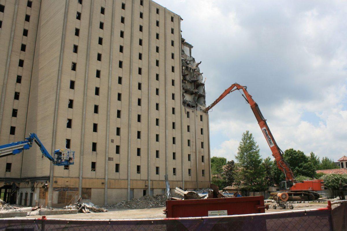 A crane's arm extends into Kirby Smith, the beginning of the building's destruction, on Friday, May 20, 2022.