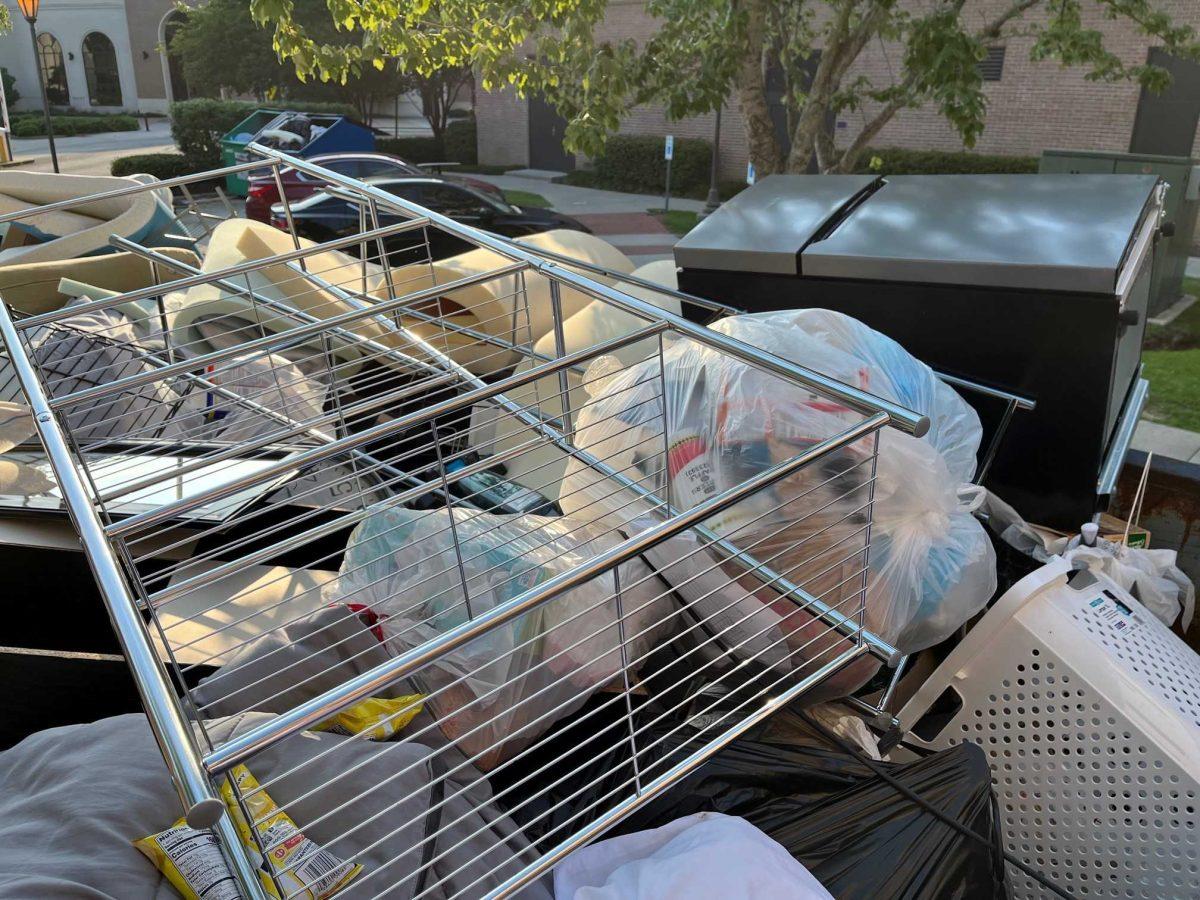 Multiple mattress pads, furniture items and a mini fridge can be seen atop the "waste" of the South Hall's dumpster on Saturday, May 14, 2022.