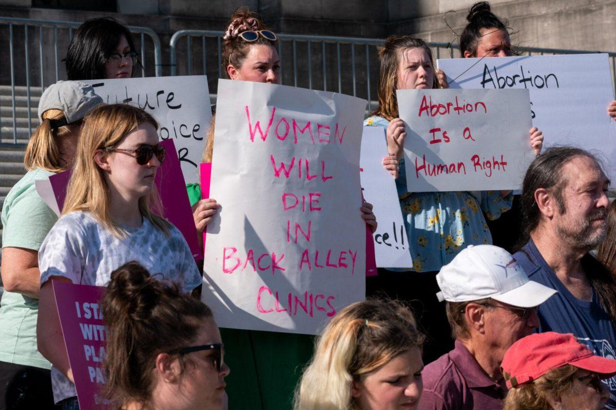 Advocates display, on homemade signs, warnings of a future when abortion is banned.