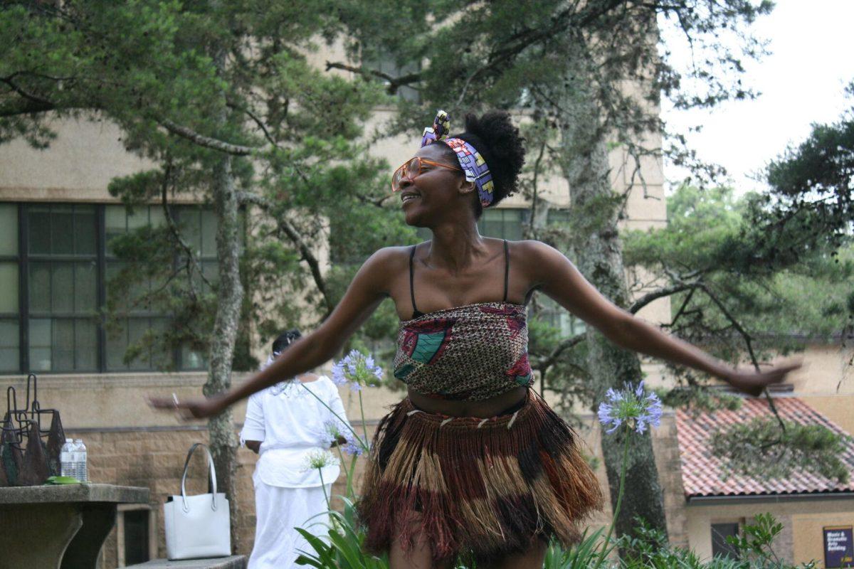 Dominique Clayton honors the ancestors at the Libation Ceremony on Wednesday, May 12, 2022 by dancing.