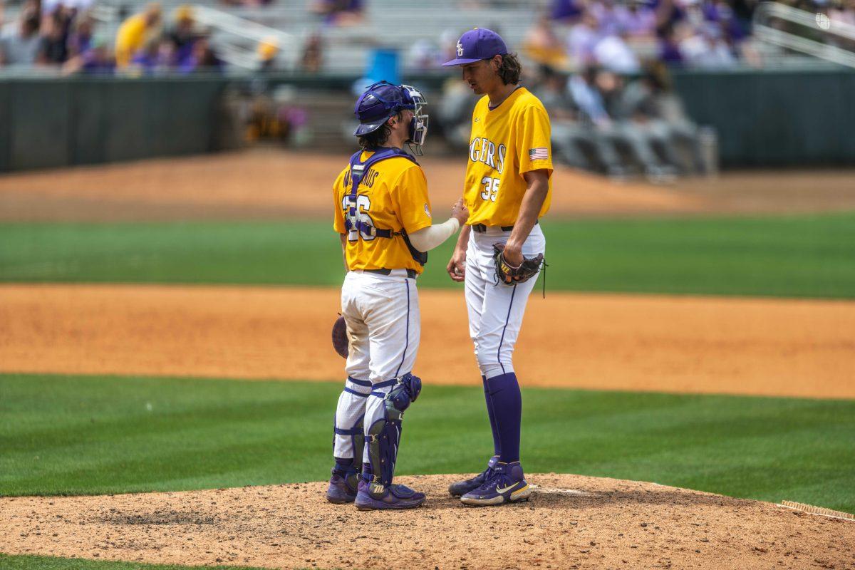 LSU baseball graduate catcher Tyler McManus (26) says some words of encouragement to redshirt sophomore right-handed pitcher Paul Gervase (35) Saturday, April 23, 2022, during LSU's 8-6 win over Missouri at Alex Box Stadium.