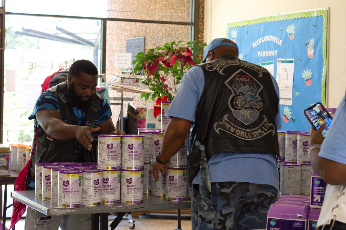 Malcolm Baker and Dave Williams, of the Down South Burners Motorcycle Club, help hand out formula at a recent formula drive. / Photo credit: Allison Allsop, The Reveille