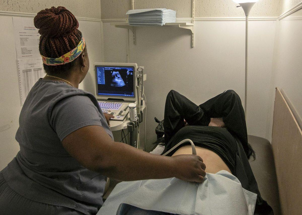 Operating room technician Nikki Jordan performs an ultrasound on a patient at Hope Medical Group for Women in Shreveport, La., Wednesday, July 6, 2022. She tells each patient, "You have the right to ask me any question. You have the right to take a picture home with you. You have the right to hear the heartbeat." "Most take a glimpse (of the ultrasound) and hand it back." Nearly two weeks after the 1973 Roe vs Wade decision was overturned, the abortion clinic is still providing abortions. But the Hope Medical Group for Women faces a looming court case on Friday that could spell an end to that. (AP Photo/Ted Jackson)