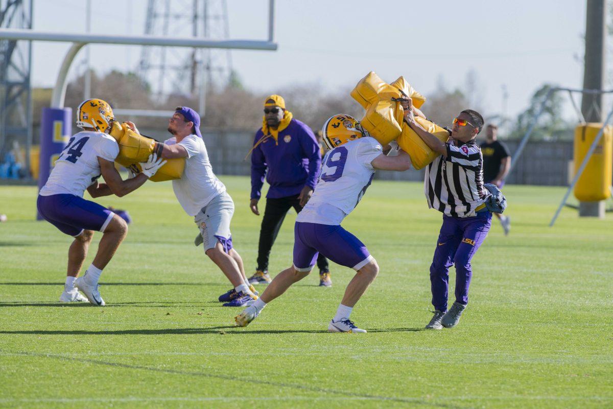 LSU football cornerback Jarrick Bernard-Converse (24) and wide receiver Jack Rilling (89) run a drill Thursday, April 7, 2022, during LSU&#8217;s spring practice in Baton Rouge, Louisiana.