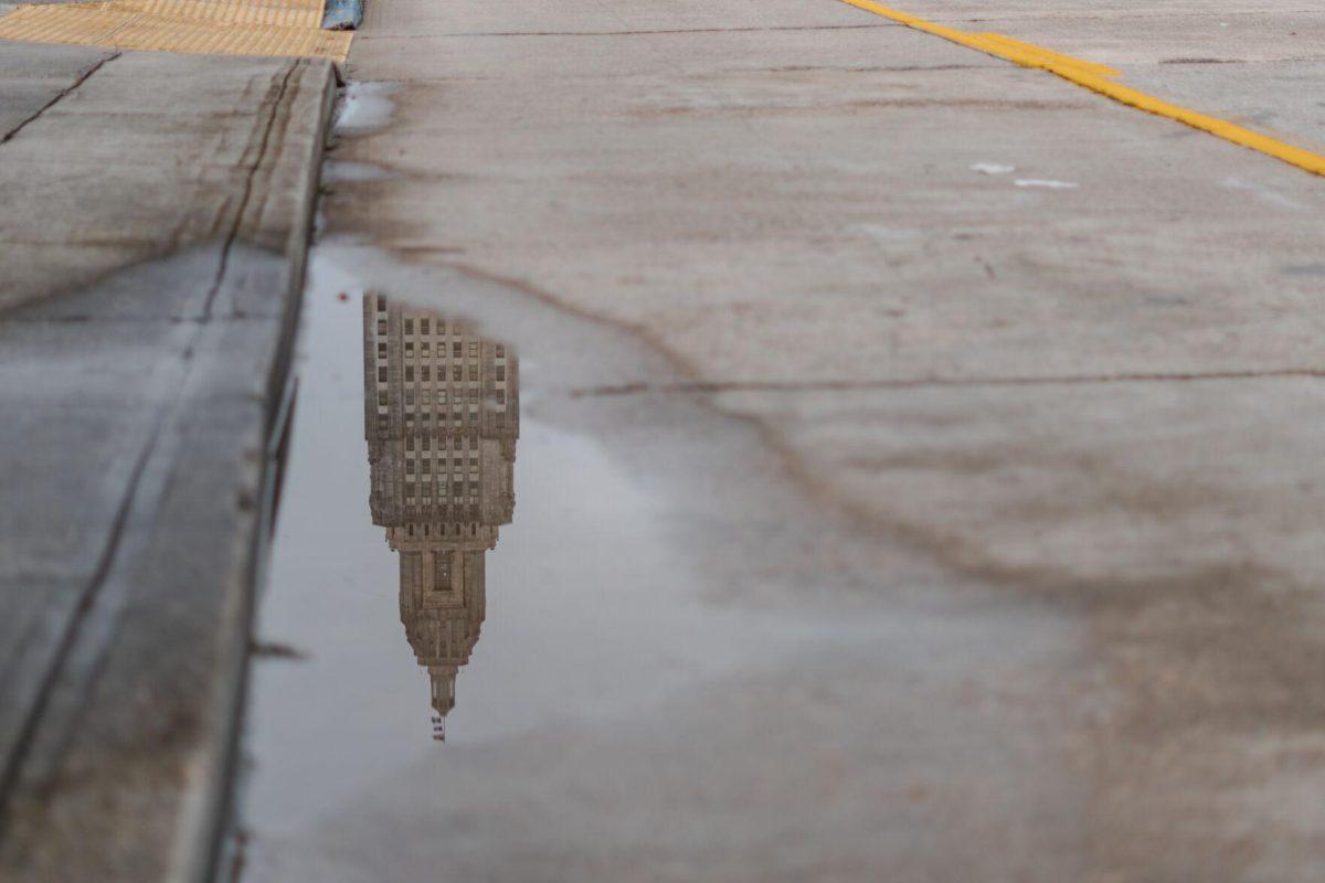 The Louisiana State Capitol reflects in a puddle on Monday, Aug. 22, 2022, on North 3rd Street in Baton Rouge, La.