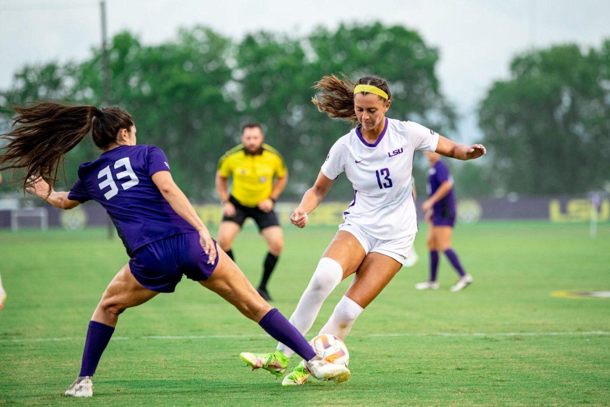 LSU soccer redshirt junior forward Taylor Dobles (13) and Stephen F. Austin women’s soccer senior defender Destiny Ramirez (33) fight for the ball Thursday, Aug. 18, 2022, during LSU’s 5-0 win against Stephen F. Austin at LSU's Soccer Stadium off of Nicholson Drive.