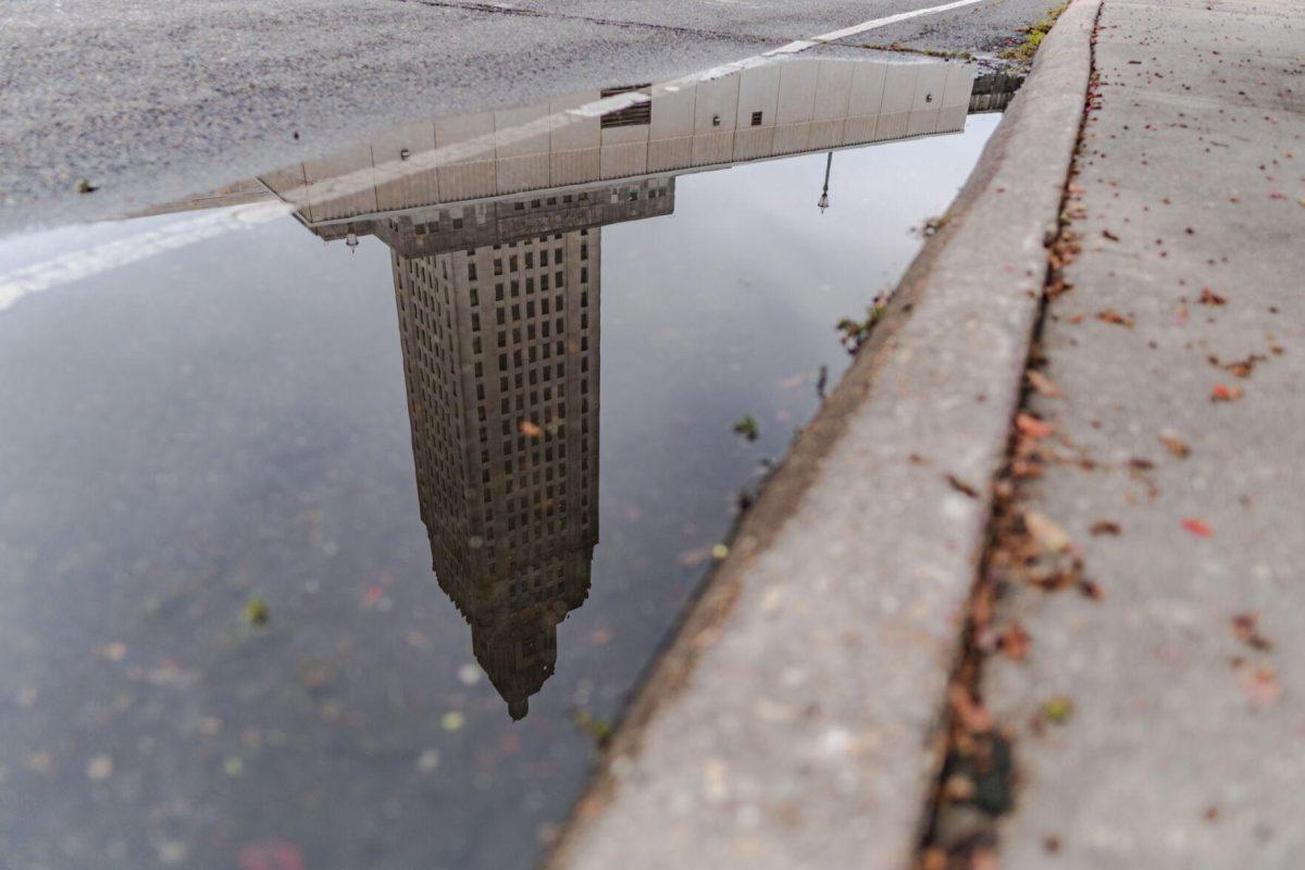 The State Capitol reflects in a puddle on Monday, Aug. 22, 2022, on North 3rd Street in Baton Rouge, La.