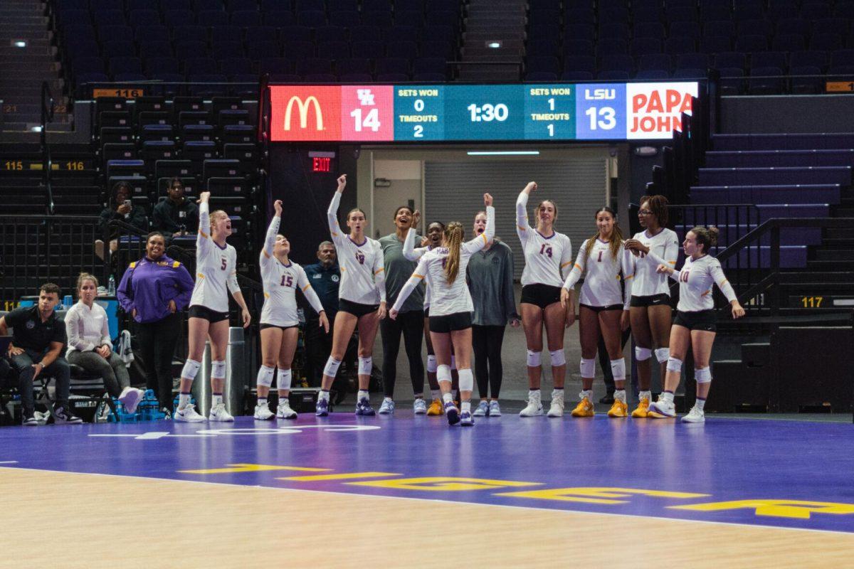 LSU volleyball players on the sideline participate in a cheer on Friday, Aug. 26, 2022, during their 3-1 loss against Houston in the Pete Maravich Assembly Center in Baton Rouge, La.