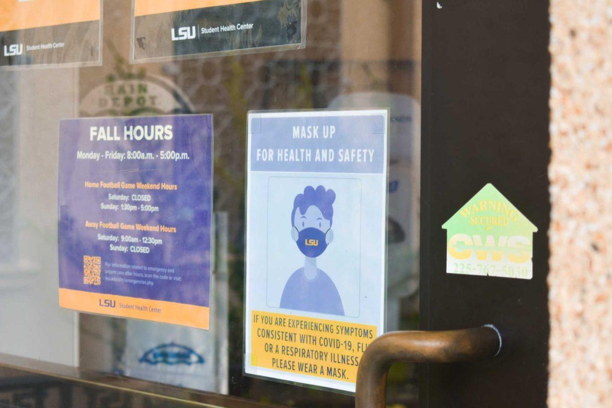 A &#8220;Mask Up&#8221; poster remains Friday, August 19, 2022, on the door of the LSU Student Health Center on Infirmary Road, Baton Rouge, La.