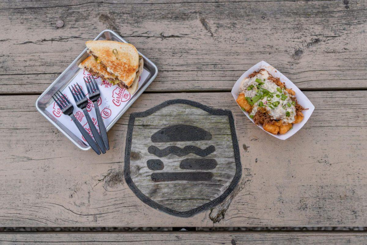 The special Hatch Chile Month dishes sit next to the logo on Monday, Aug. 29, 2022, at Curbside Burgers on Government Street in Baton Rouge, La.