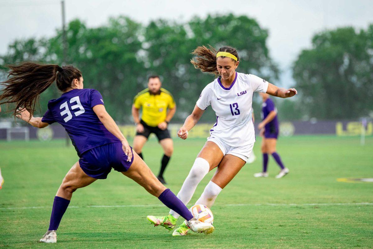 LSU soccer redshirt junior forward Taylor Dobles (13) and Stephen F. Austin women&#8217;s soccer senior defender Destiny Ramirez (33) fight for the ball Thursday, Aug. 18, 2022, during LSU&#8217;s 5-0 win against Stephen F. Austin at LSU's Soccer Stadium off of Nicholson Drive.