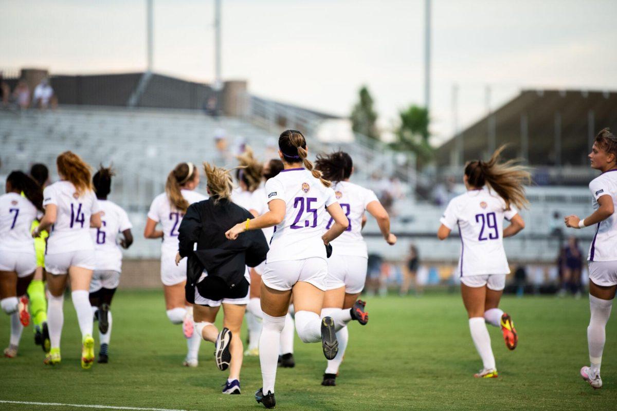 The LSU soccer team runs onto the pitch Thursday, Aug. 18, 2022, before LSU's 5-0 win against Stephen F. Austin at LSU's Soccer Stadium off of Nicholson Drive.