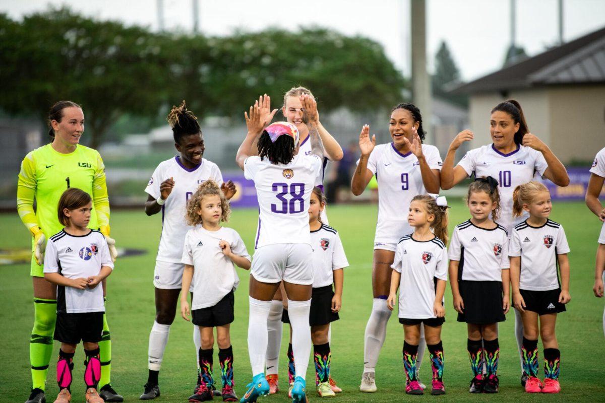 LSU soccer senior forward Rammie Noel (28) high fives fifth-year senior defender Shannon Cooke (8) Thursday, Aug. 18, 2022, before LSU’s 5-0 win against Stephen F. Austin at LSU's Soccer Stadium off of Nicholson Drive.