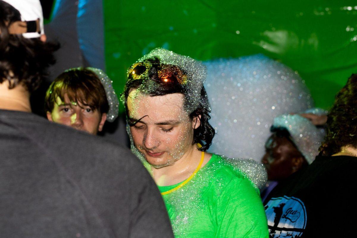 A LSU student stands in the foam pit Wednesday, Aug. 17, 2022, during the LSU Welcome Week Foam Party on Tower Drive in Baton Rouge, La.