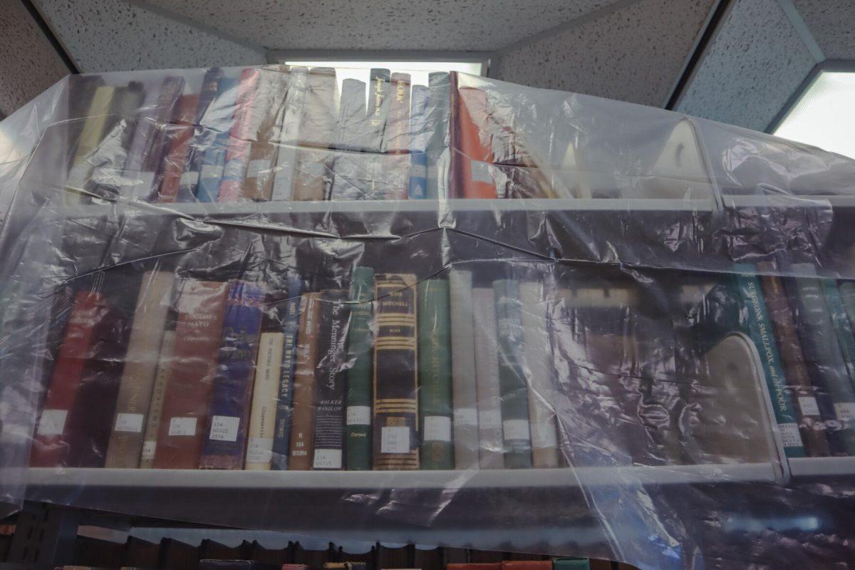 Tarping covers books on Tuesday, Aug. 30, 2022, inside of the LSU Library on Tower Drive in Baton Rouge, La.