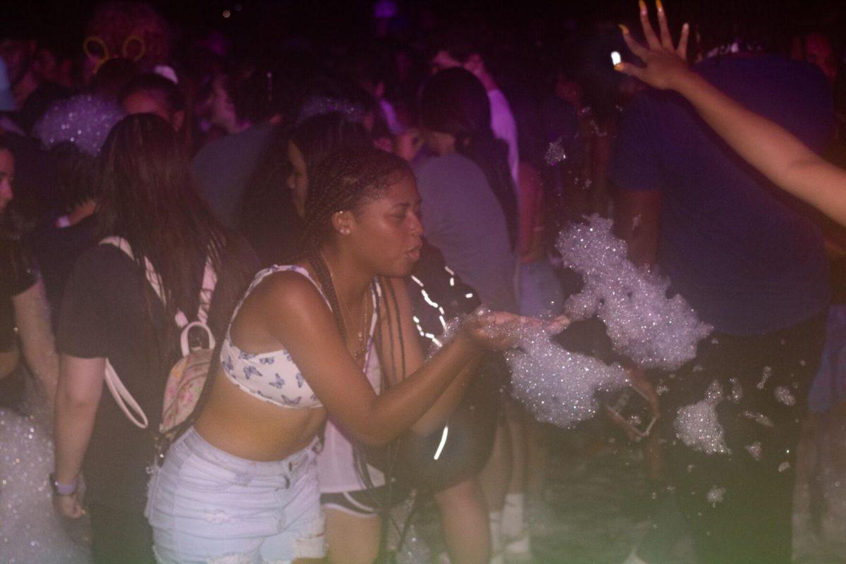 A LSU student blows foam Wednesday, Aug. 17, 2022, during the LSU Welcome Week Foam Party on Tower Drive in Baton Rouge, La.