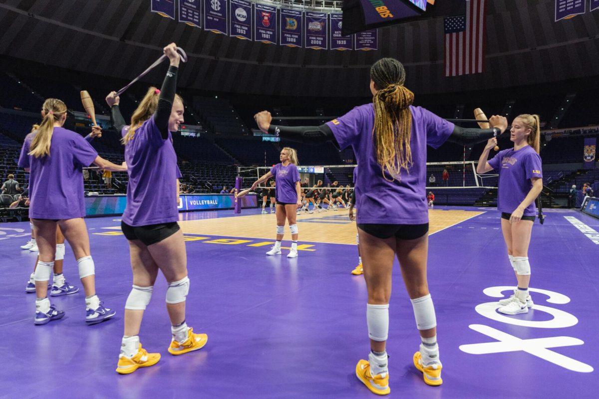 Members of the LSU volleyball team stretch on Friday, Aug. 26, 2022, prior to their 3-1 loss against Houston in the Pete Maravich Assembly Center in Baton Rouge, La.