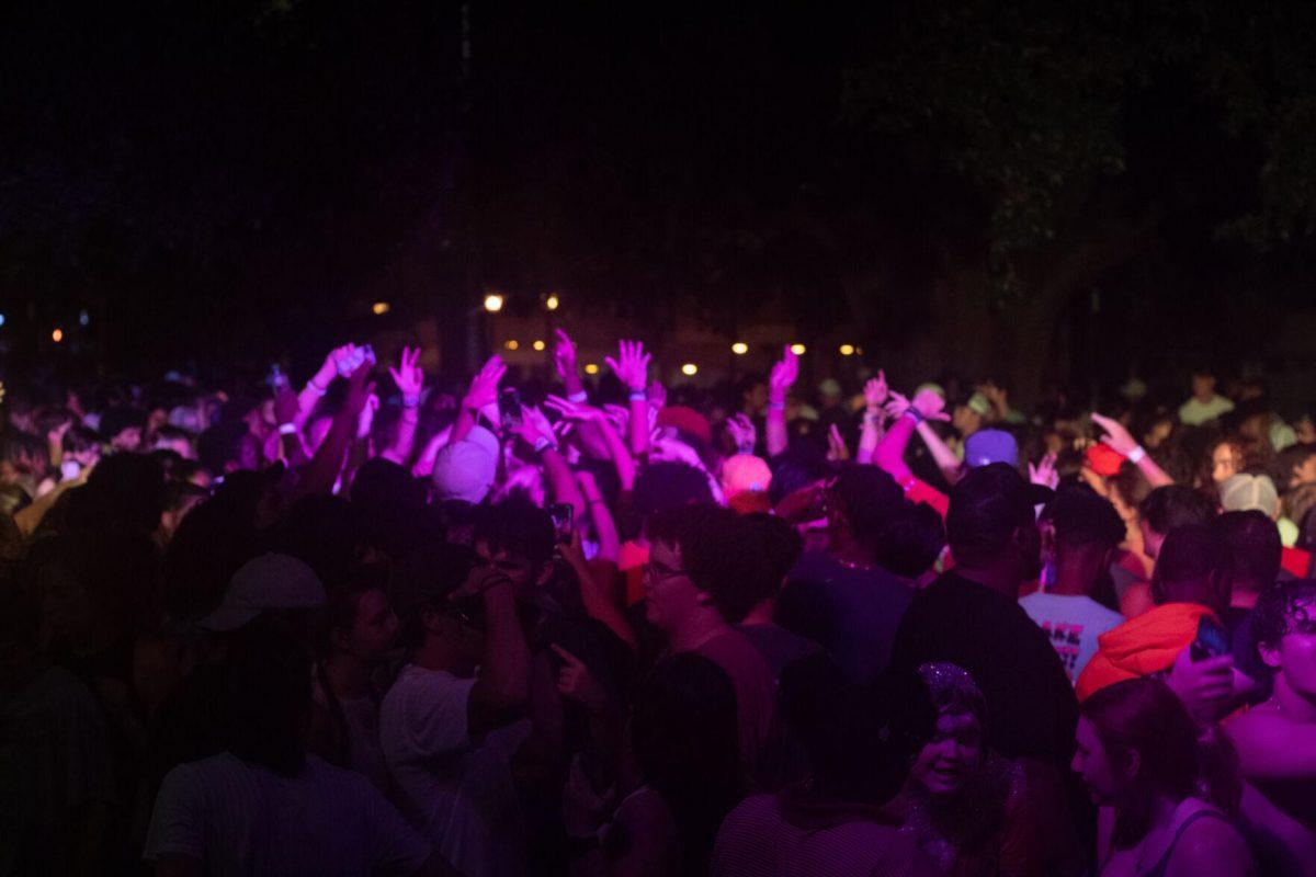 LSU students raise their hands to the music Wednesday, Aug. 17, 2022, during the LSU Welcome Week Foam Party on Tower Drive in Baton Rouge, La.