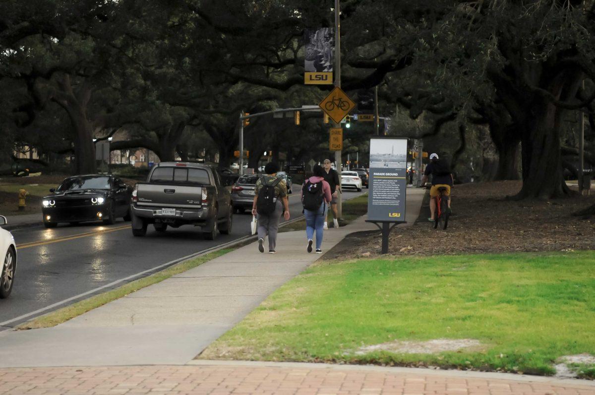 LSU students walk along the sidewalk on Wednesday, Feb. 2, 2022, at LSU's campus in Baton Rouge, La.