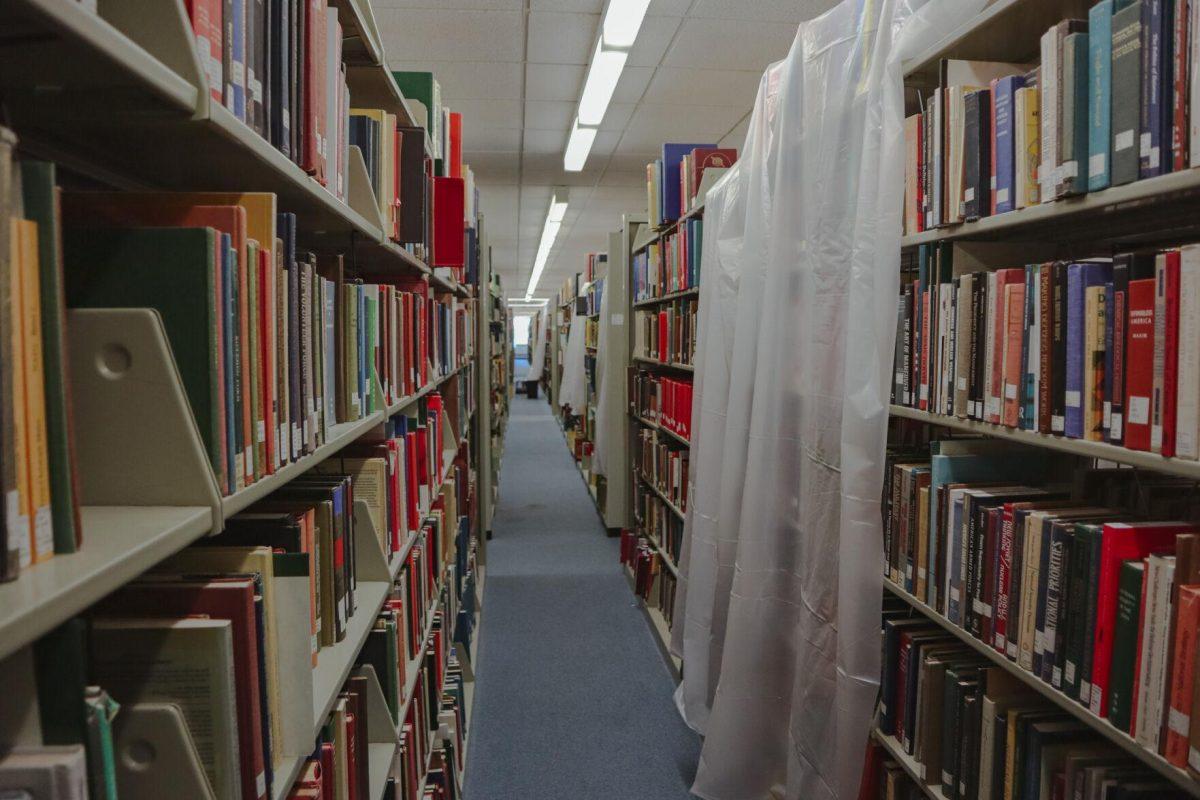 Tarps cover some sections of the bookshelves on Tuesday, Aug. 30, 2022, inside of the LSU Library on Tower Drive in Baton Rouge, La.