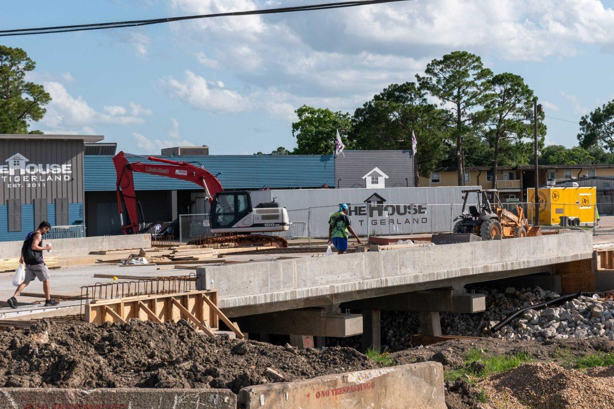 People are seen crossing the incomplete bridge into the Tigerland area Monday, May 30, 2022.