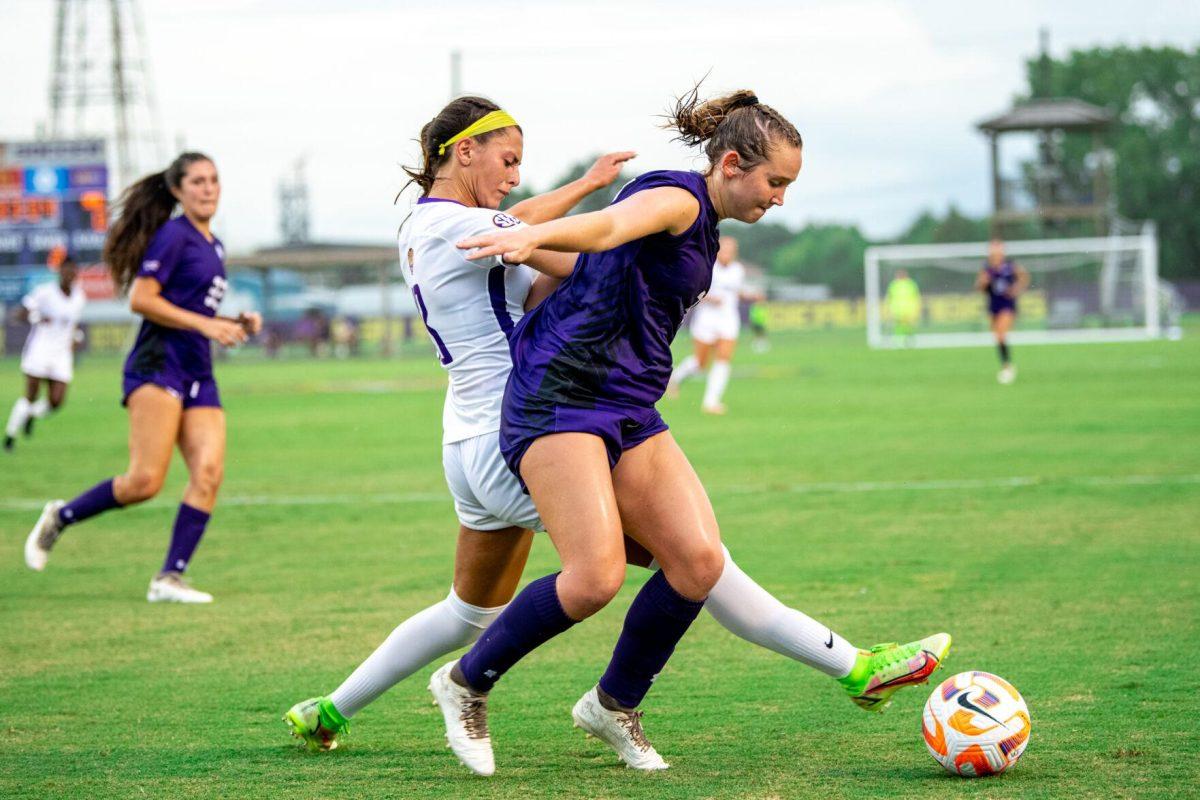 LSU soccer redshirt junior forward Taylor Dobles (13) and Stephen F. Austin women’s soccer fifth-year defender Paige Kanipes (3) fight for the ball Thursday, Aug. 18, 2022, during LSU’s 5-0 win against Stephen F. Austin at LSU's Soccer Stadium off of Nicholson Drive.