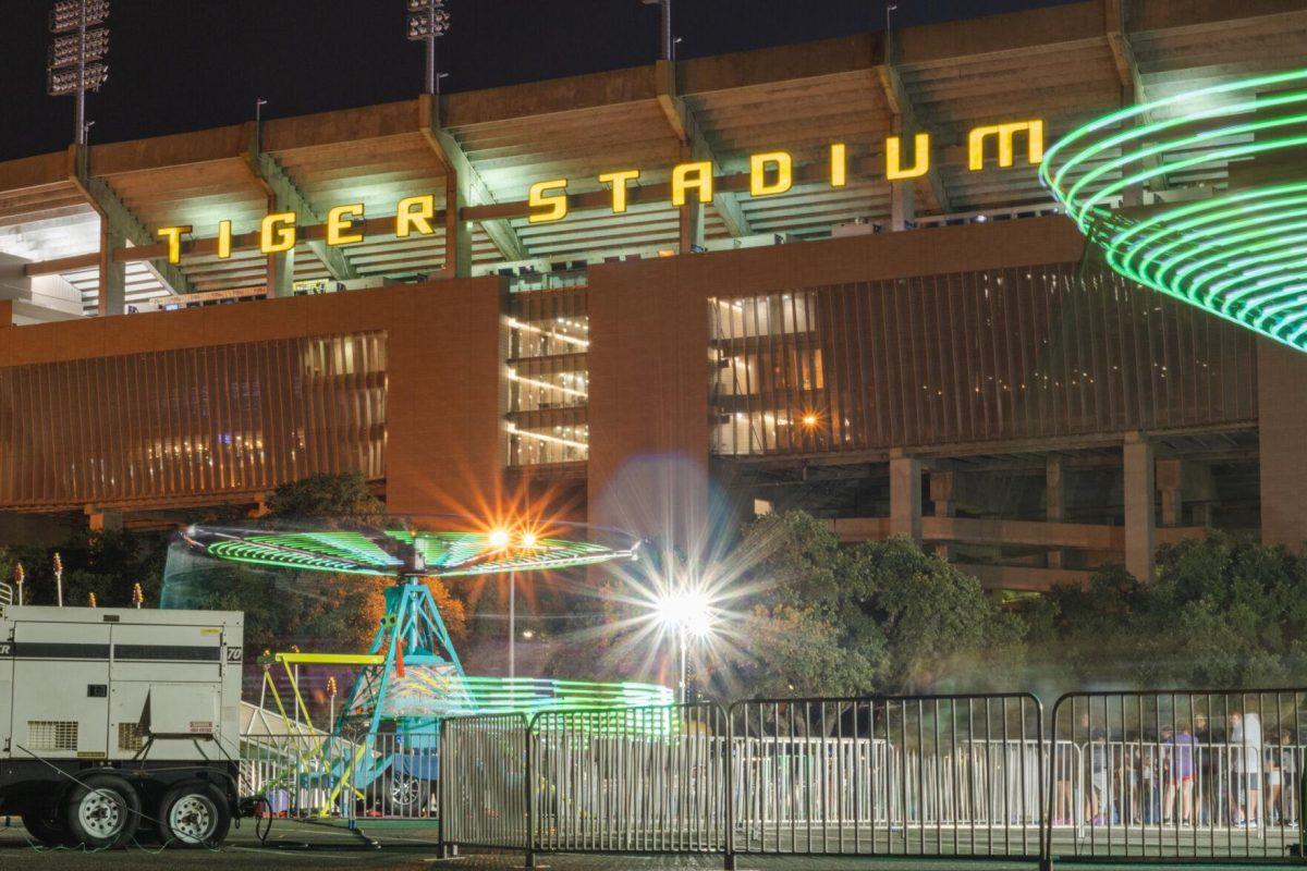 Tiger Stadium rises above the carnival action on Saturday, Aug. 20, 2022, on South Stadium Drive in Baton Rouge, La.