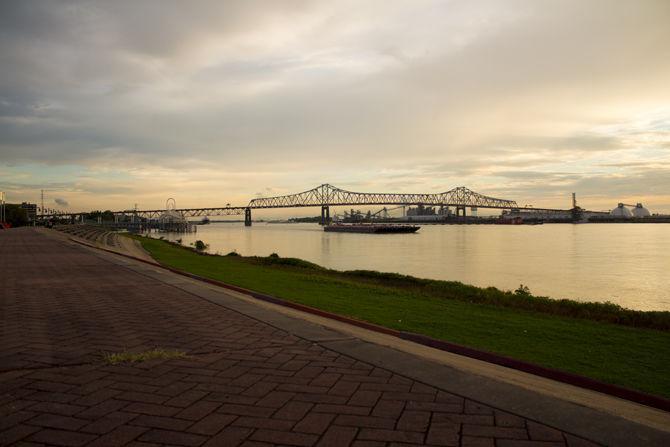 The Mississippi River runs through downtown Baton Rouge on the evening of Sunday, Sept. 23, 2018. The Horace Wilkinson bridge can be seen crossing the bridge in the distance.