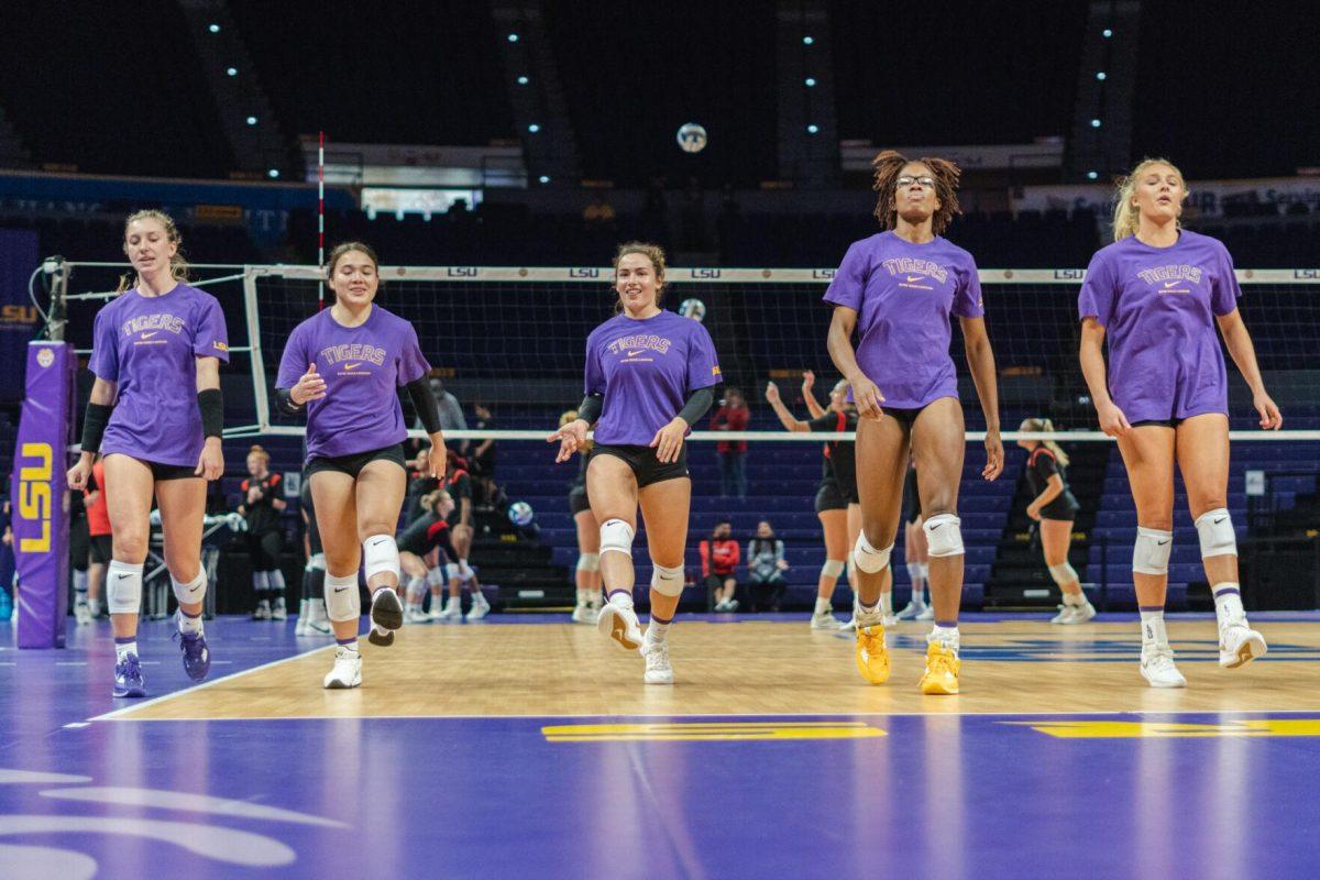 The LSU volleyball team warms up on Friday, Aug. 26, 2022, prior to their 3-1 loss against Houston in the Pete Maravich Assembly Center in Baton Rouge, La.