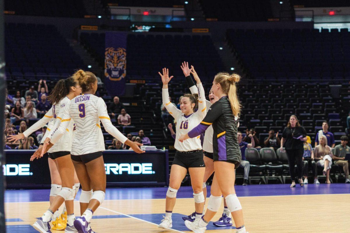 The LSU volleyball team celebrates a point on Friday, Aug. 26, 2022, during their 3-1 loss against Houston in the Pete Maravich Assembly Center in Baton Rouge, La.