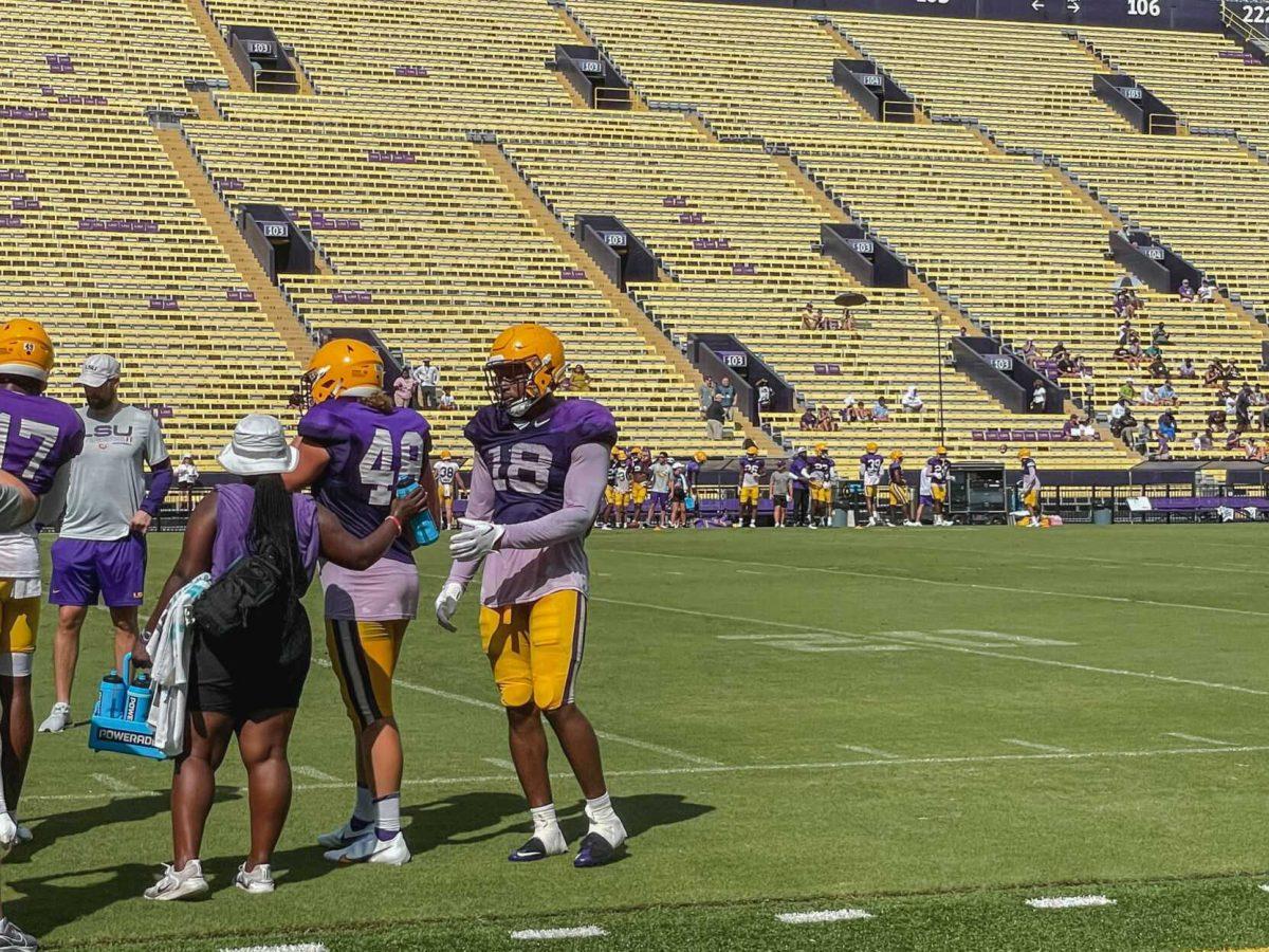 LSU football junior defensive end BJ Ojulari (18) reaches for a water bottle on Saturday, August 20, 2022, during practice at Tiger Stadium on North Stadium Drive in Baton Rouge, La.