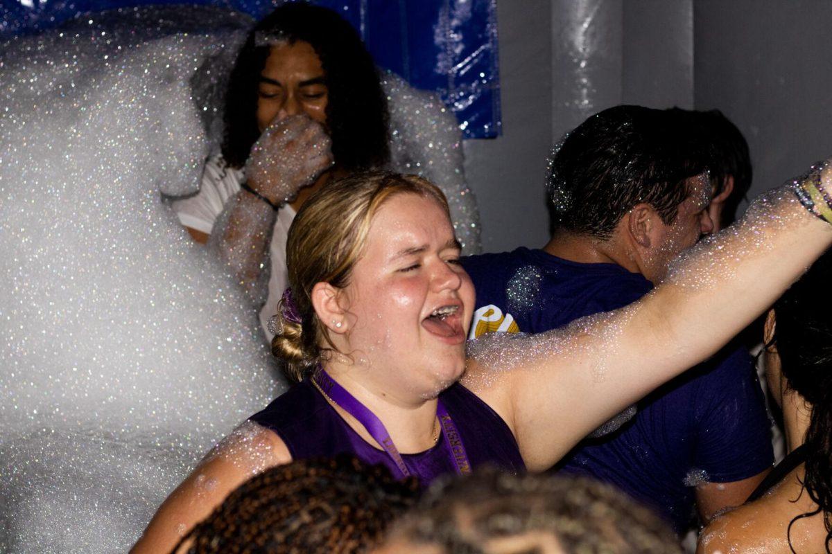 A LSU student sings in the foam pit Wednesday, Aug. 17, 2022, during the LSU Welcome Week Foam Party on Tower Drive in Baton Rouge, La.