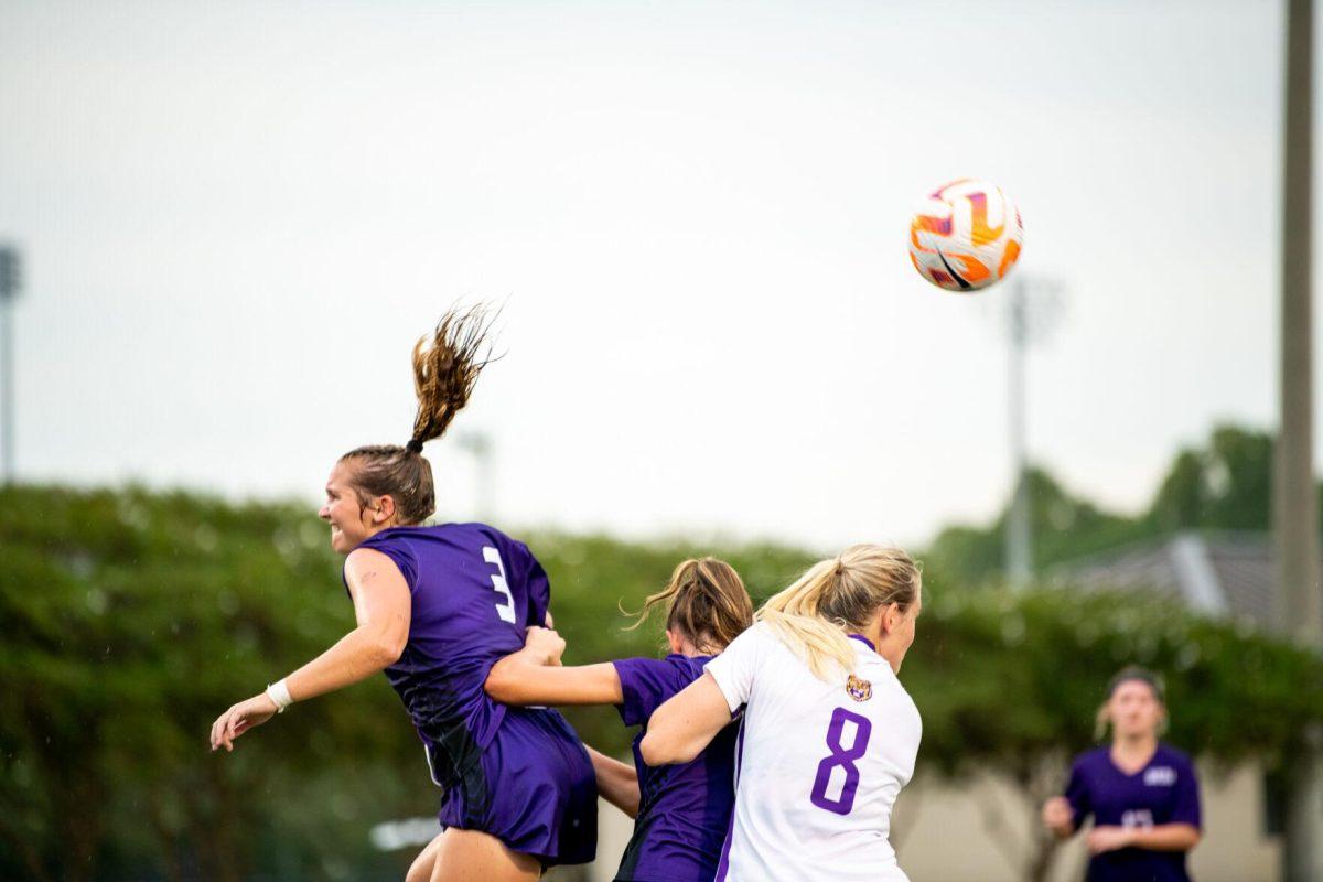 LSU soccer fifth-year senior defender Shannon Cooke (8) takes on two Stephen F. Austin defenders for the header Thursday, Aug. 18, 2022, before LSU’s 5-0 win against Stephen F. Austin at LSU's Soccer Stadium off of Nicholson Drive.