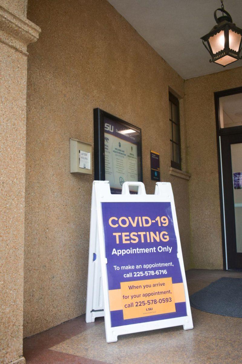 A Covid-19 testing sign stands Friday, August 19, 2022, in front of the doors of the LSU Student Health Center on Infirmary Road, Baton Rouge, La.