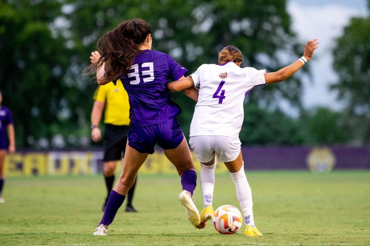 LSU soccer freshman forward Sage Glo (4) and Stephen F. Austin women’s soccer senior defender Destiny Ramirez (33) fight for the ball Thursday, Aug. 18, 2022, during LSU’s 5-0 win against Stephen F. Austin at LSU's Soccer Stadium off of Nicholson Drive.