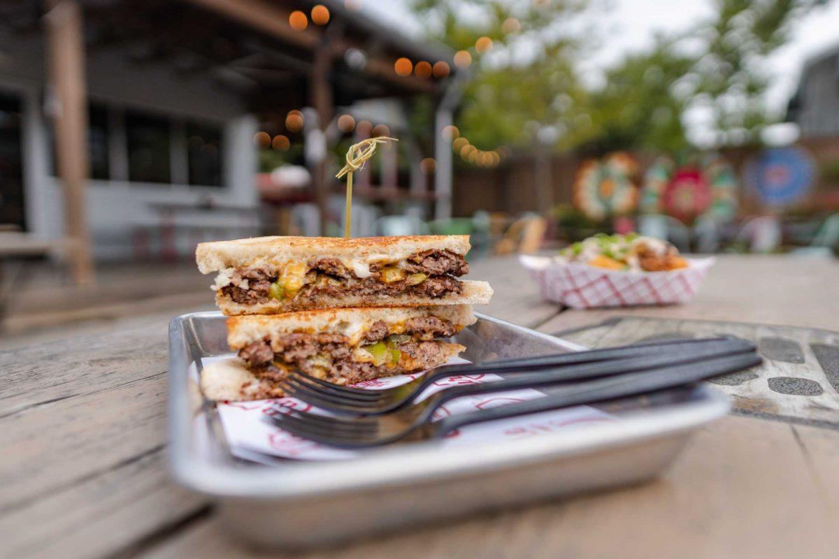 The special Hatch Chile melt sits on a picnic bench on Monday, Aug. 29, 2022, at Curbside Burgers on Government Street in Baton Rouge, La.