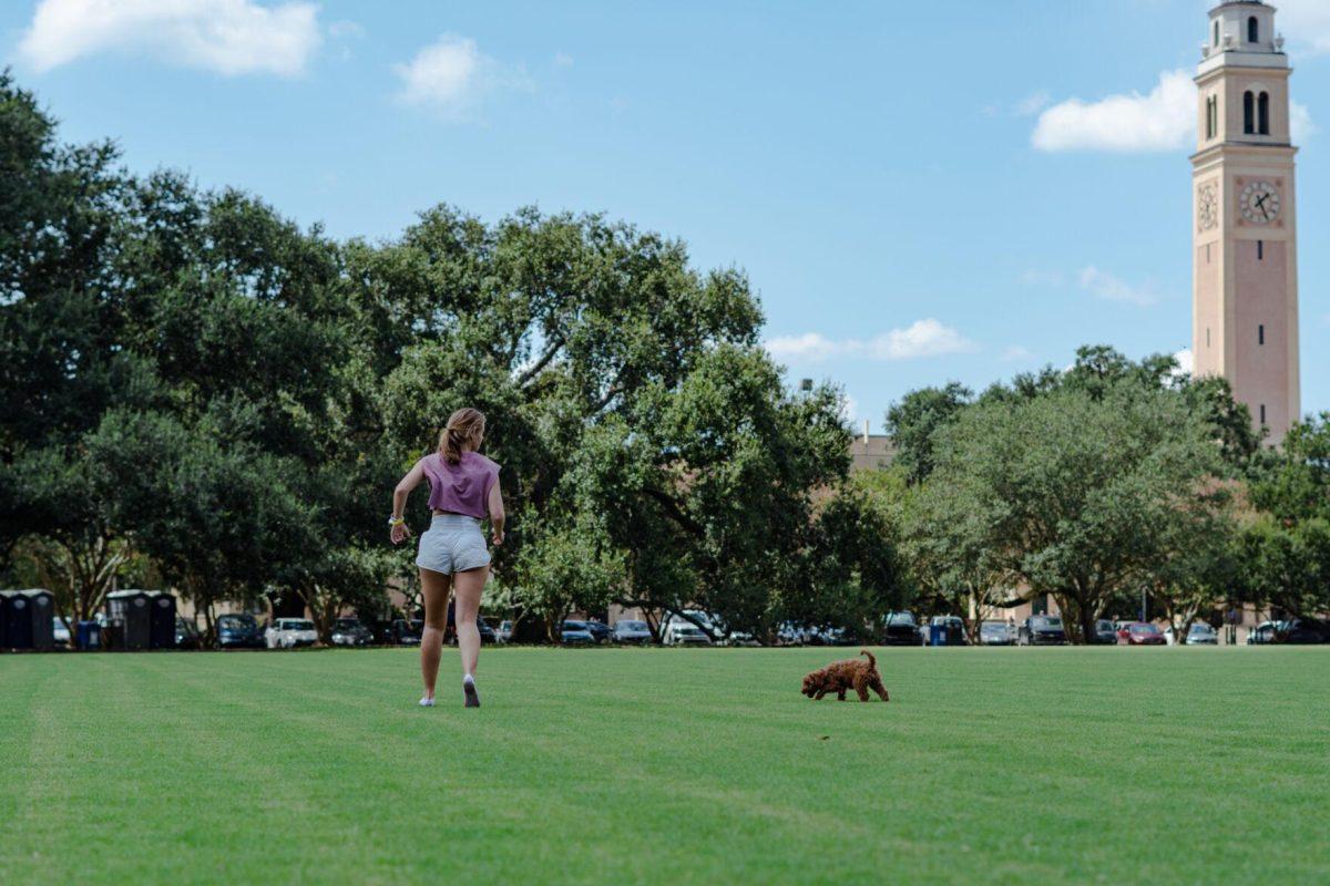 LSU kinesiology senior Caitlin Mathes runs toward her dog Cooper on Friday, Sept. 9, 2022, on the Parade Ground on Highland Road in Baton Rouge, La.