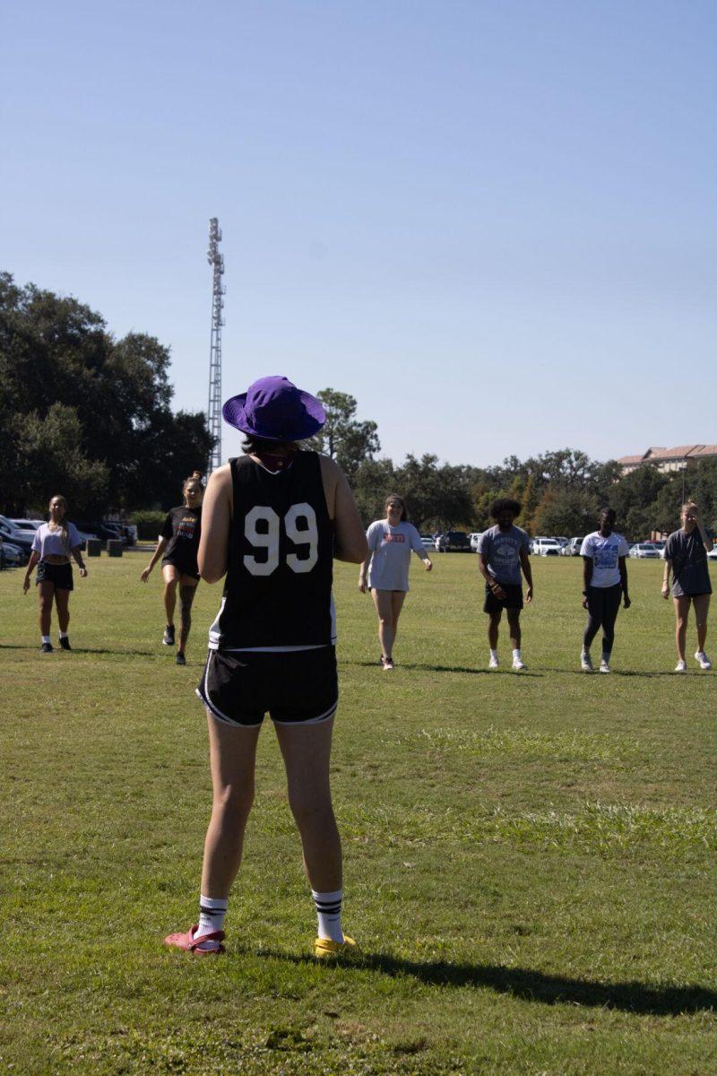 The instructor looks on as her jogging class completes warmups on Wednesday, Sept. 14, 2022, at the field by the LSU Natatorium in Baton Rouge, La.