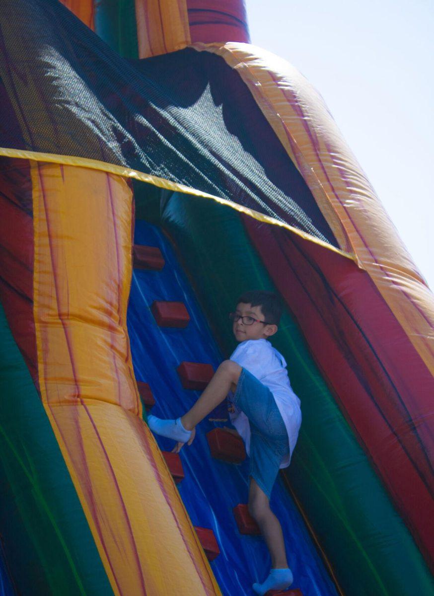 A boy climbs an inflatable slide at the LSU Family Weekend Tailgate on Saturday, Sept. 24, 2022, on the LSU Parade Ground in Baton Rouge, La.