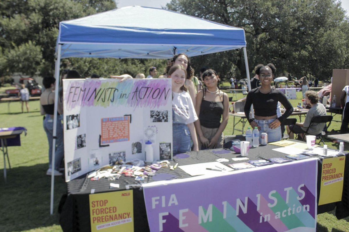 The Feminists in Action booth hands out informational flyers during Fall Fest on Friday, Sept. 16, 2022, on the LSU Parade Ground.