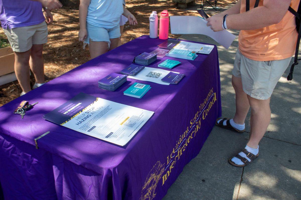 A student visits the Infraternity Council's table on Tuesday, Sept 20, 2022, in Free Speech Alley on LSU's Campus.