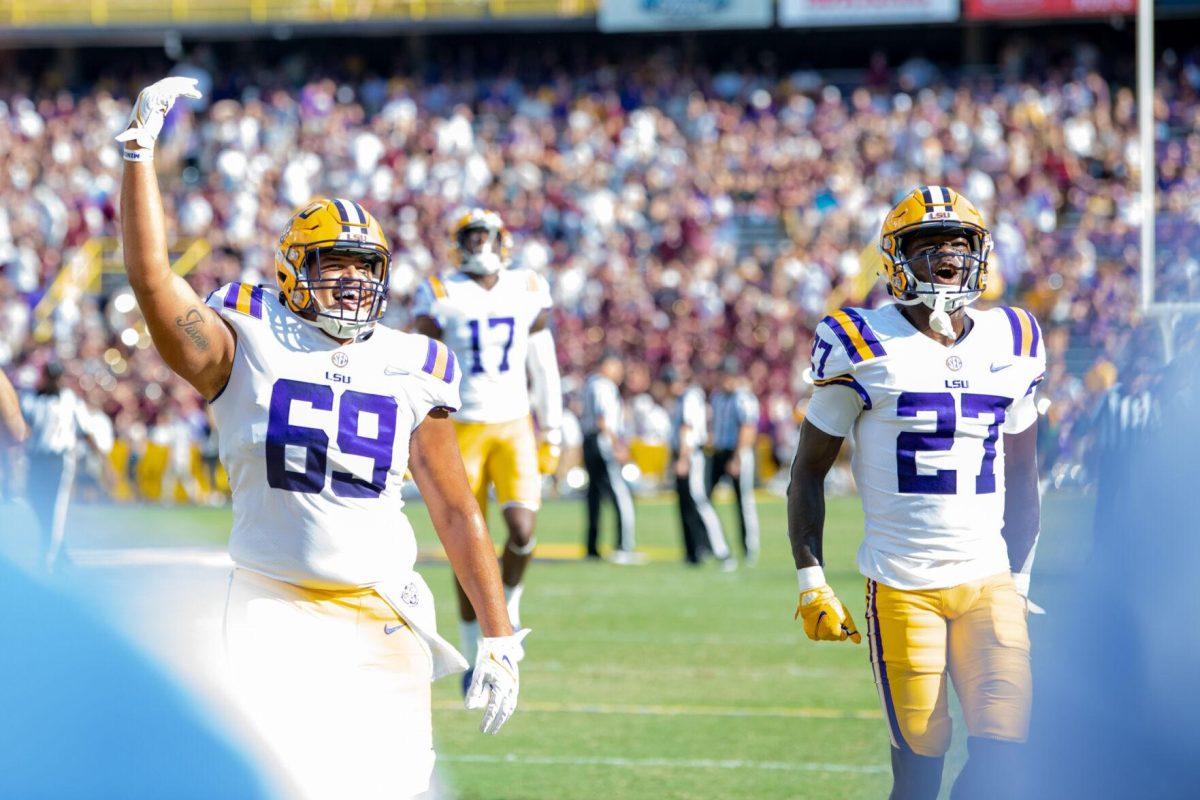 LSU football junior offensive lineman Charles Turner (69) and freshman cornerback Laterrance Welch (27) hype up the crowd Saturday, Sept. 17, 2022 before LSU’s 31-16 win against Mississippi State at Tiger Stadium in Baton Rouge, La.
