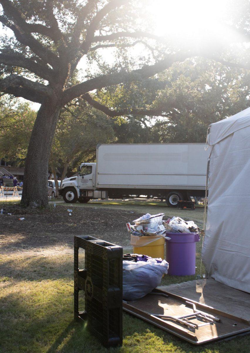 Overflowing garbage cans sit on the LSU Parade Ground after tailgating on Saturday, Sept. 24, 2022, in Baton Rouge, La.